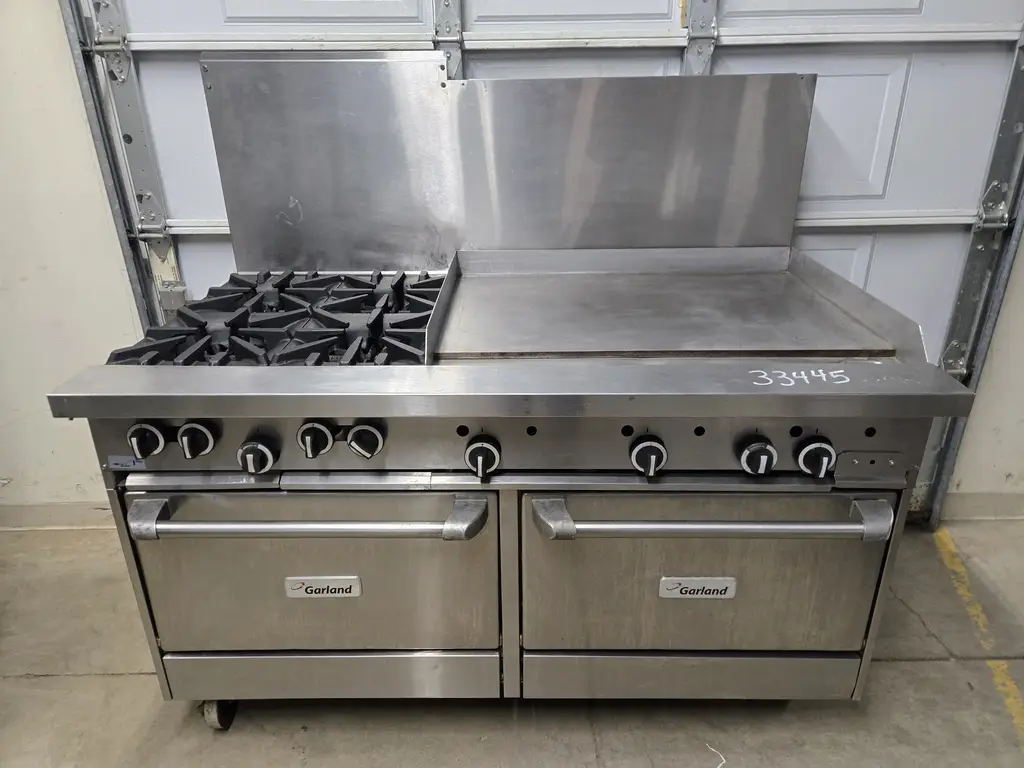 GARLAND 4 BURNER RANGE WITH 35 INCH GRIDDLE ON RIGHT AND STANDARD OVEN ON CASTERS NSF