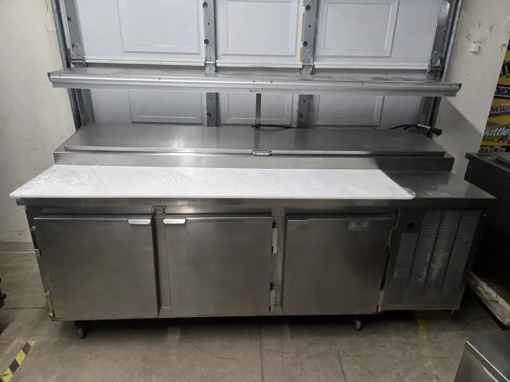 KAIRAK 3 DOOR PIZZA PREP TABLE ON CASTERS - WRAP RAIL - 12 INCH OVER SHELF WITH CHECKMINDER